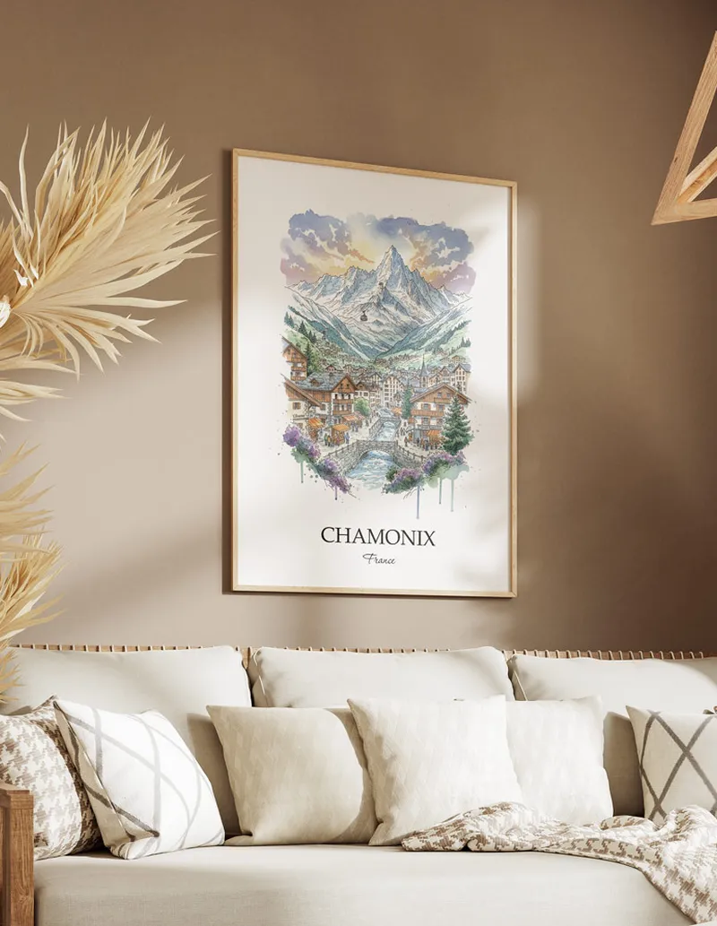Vintage travel poster of Chamonix city, France in a light frame displayed above a sofa in a bright boho interior.