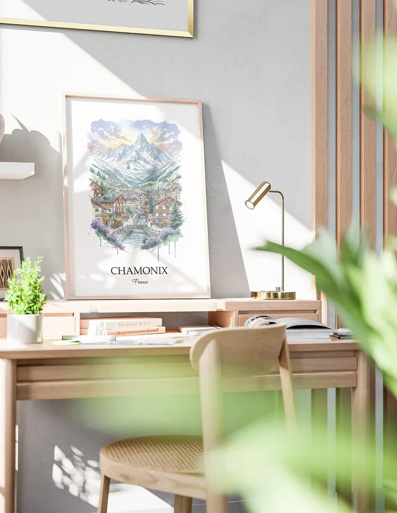 Cozy, well-lit workspace with a minimalist poster of Chamonix, France in a light frame sitting on the desk.