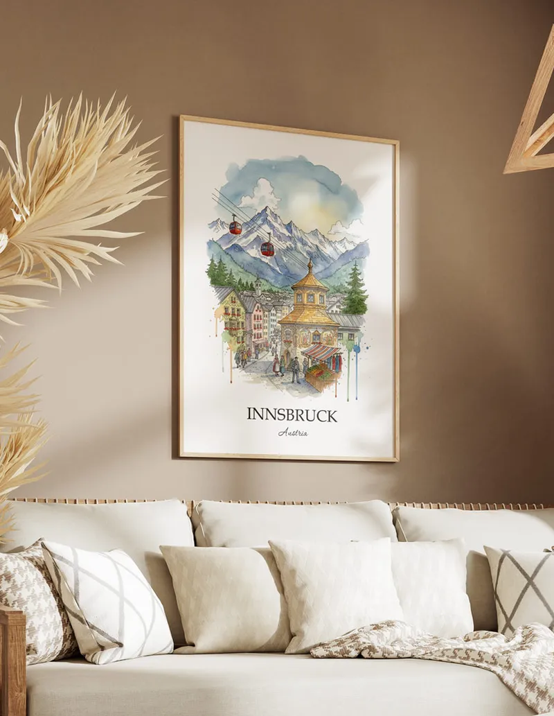 Vintage travel poster of Innsbruck city, Austria in a light frame displayed above a sofa in a bright boho interior.