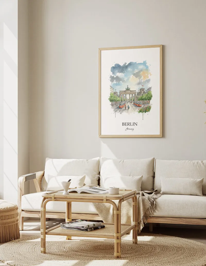 Framed wall art featuring Berlin, Germany in a light wood frame hanging above a sofa in a modern living room.