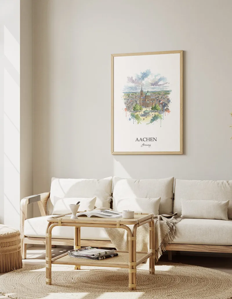 Framed wall art featuring Aachen, Germany in a light wood frame hanging above a sofa in a modern living room.
