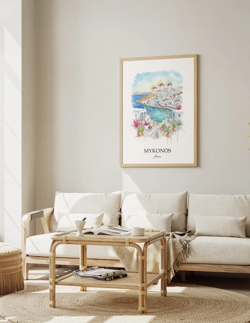 Framed wall art featuring Mykonos (Chora), Greece in a light wood frame hanging above a sofa in a modern living room.