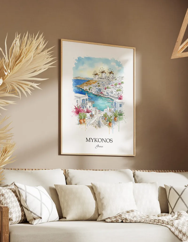 Vintage travel poster of Mykonos (Chora) city, Greece in a light frame displayed above a sofa in a bright boho interior.