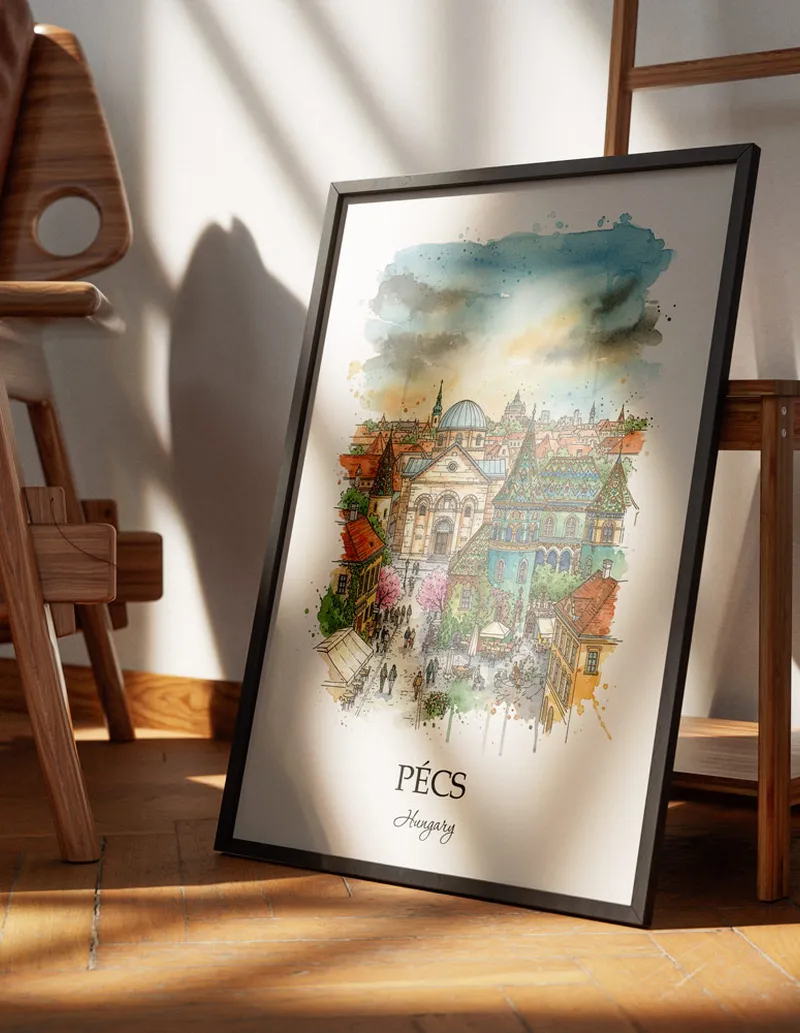 Minimalist poster of Pécs city in Hungary in a light frame standing on the floor in a dark moody interior.