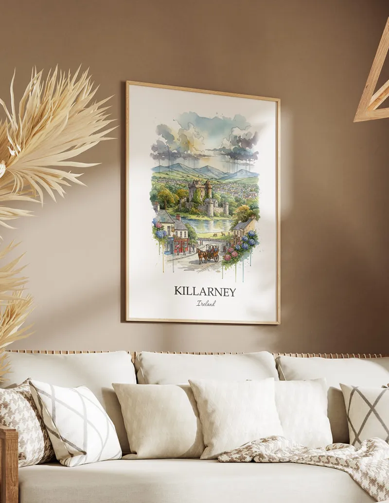 Vintage travel poster of Killarney city, Ireland in a light frame displayed above a sofa in a bright boho interior.