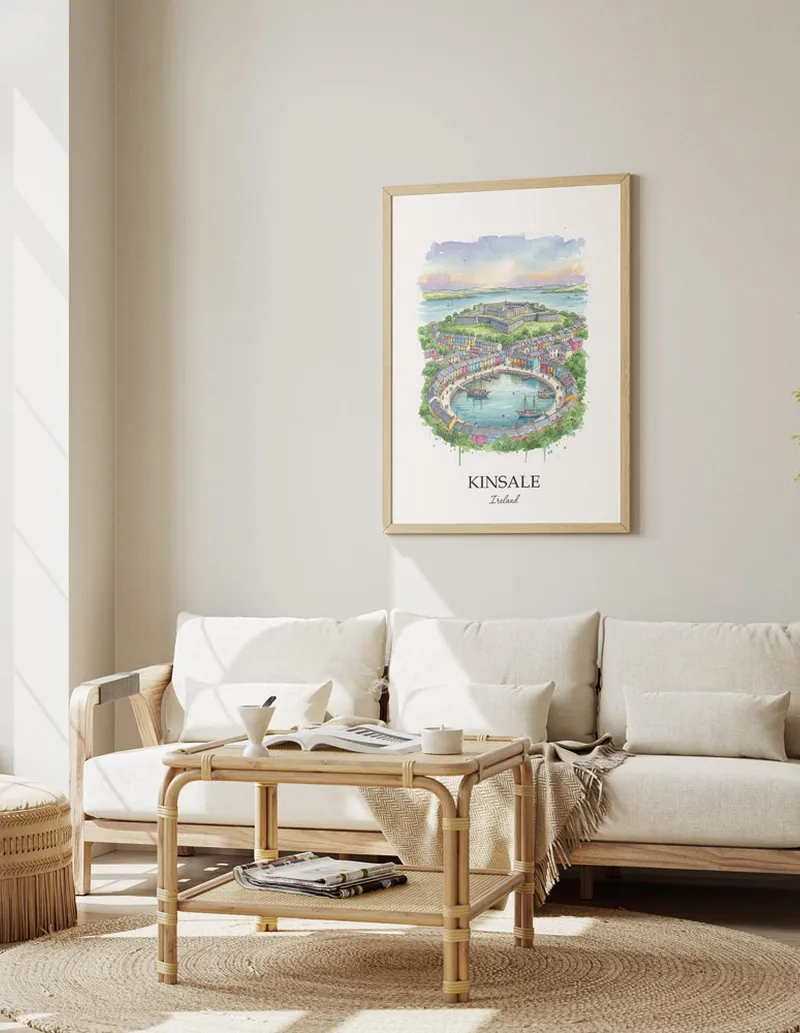 Framed wall art featuring Kinsale, Ireland in a light wood frame hanging above a sofa in a modern living room.