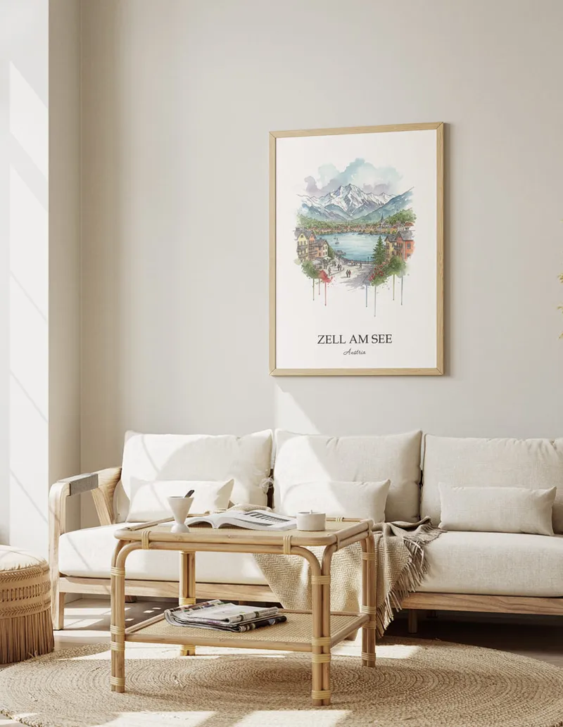 Framed wall art featuring Zell am See, Austria in a light wood frame hanging above a sofa in a modern living room.