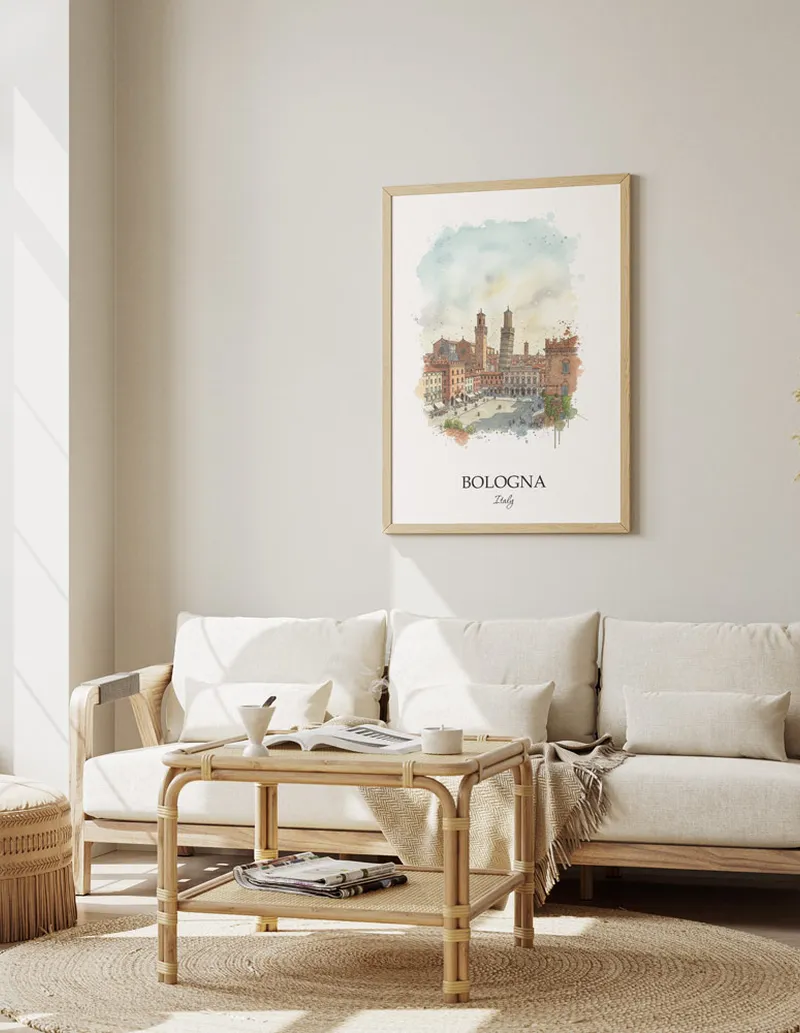 Framed wall art featuring Bologna, Italy in a light wood frame hanging above a sofa in a modern living room.