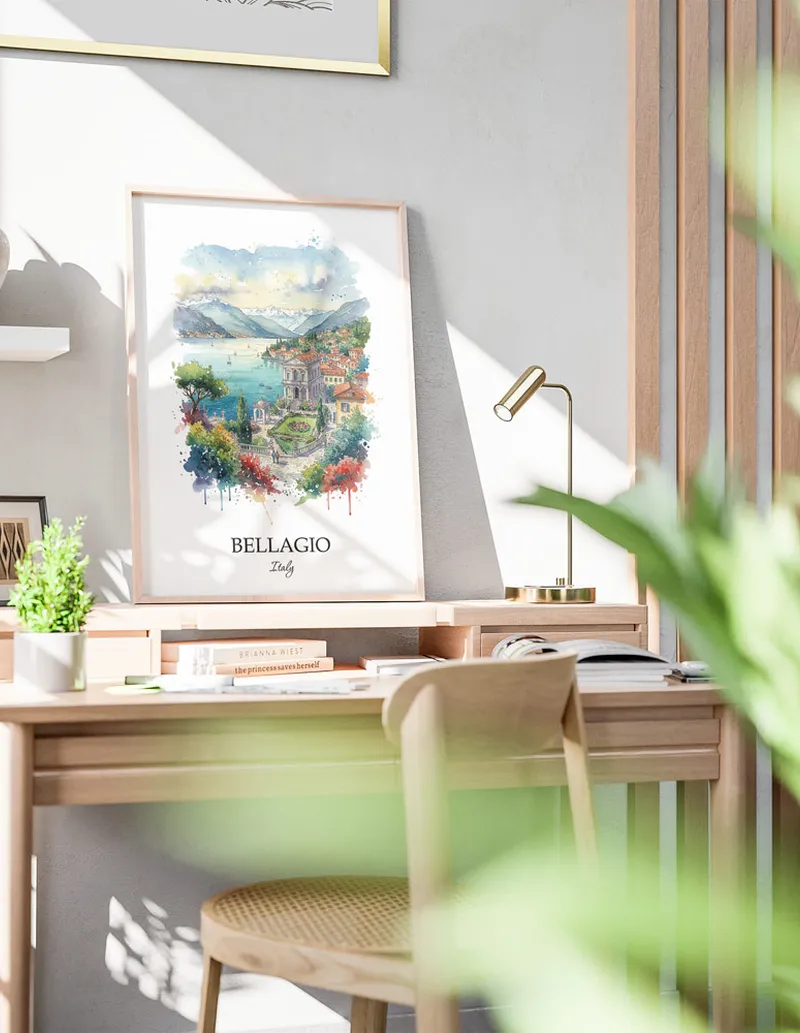 Cozy, well-lit workspace with a minimalist poster of Bellagio, Italy in a light frame sitting on the desk.