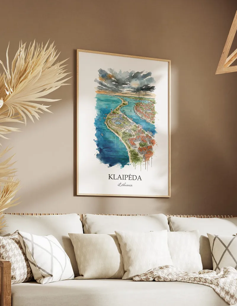 Vintage travel poster of Klaip_da city, Lithuania in a light frame displayed above a sofa in a bright boho interior.