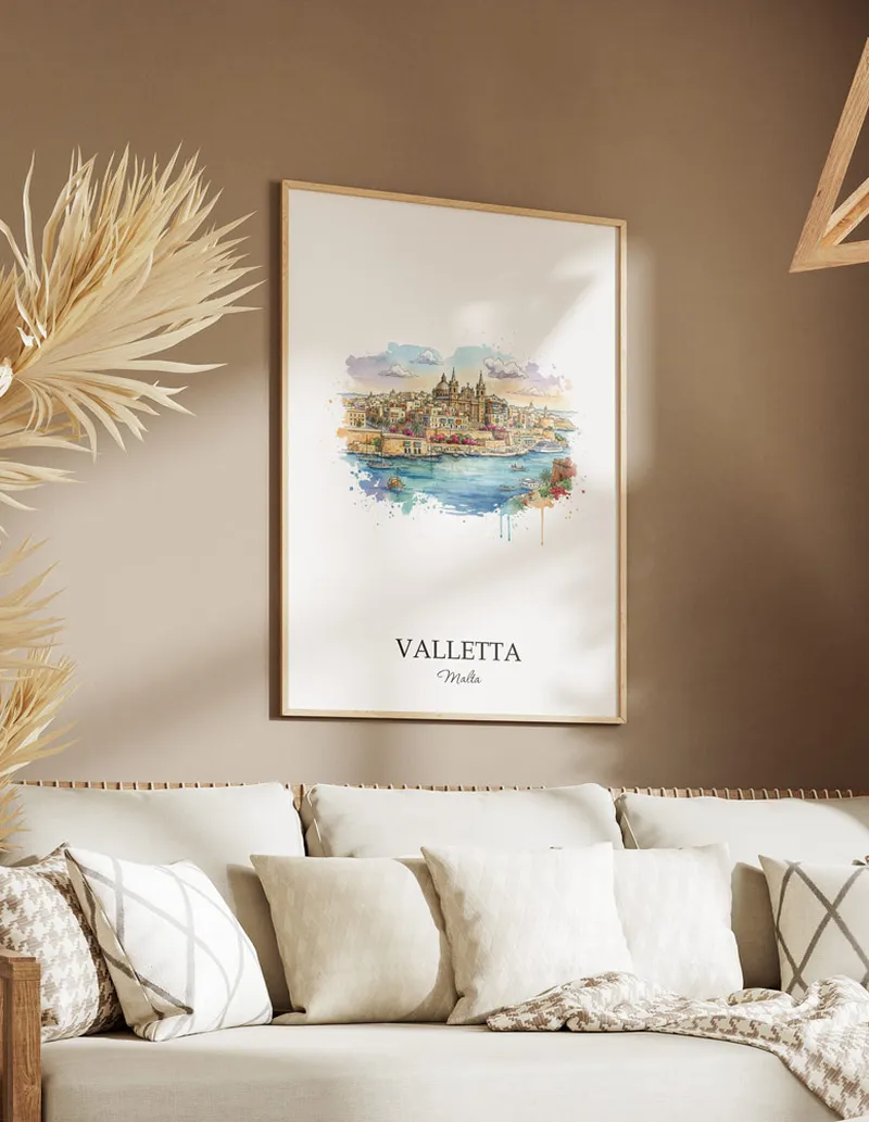 Vintage travel poster of Valletta city, Malta in a light frame displayed above a sofa in a bright boho interior.