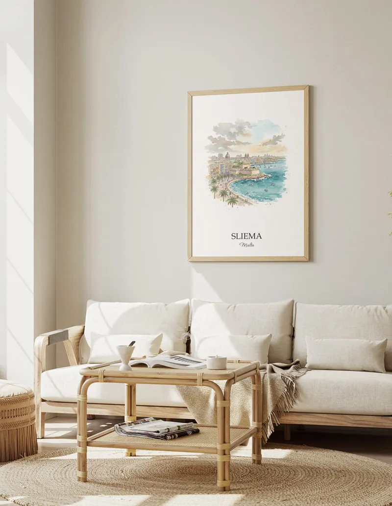 Framed wall art featuring Sliema, Malta in a light wood frame hanging above a sofa in a modern living room.