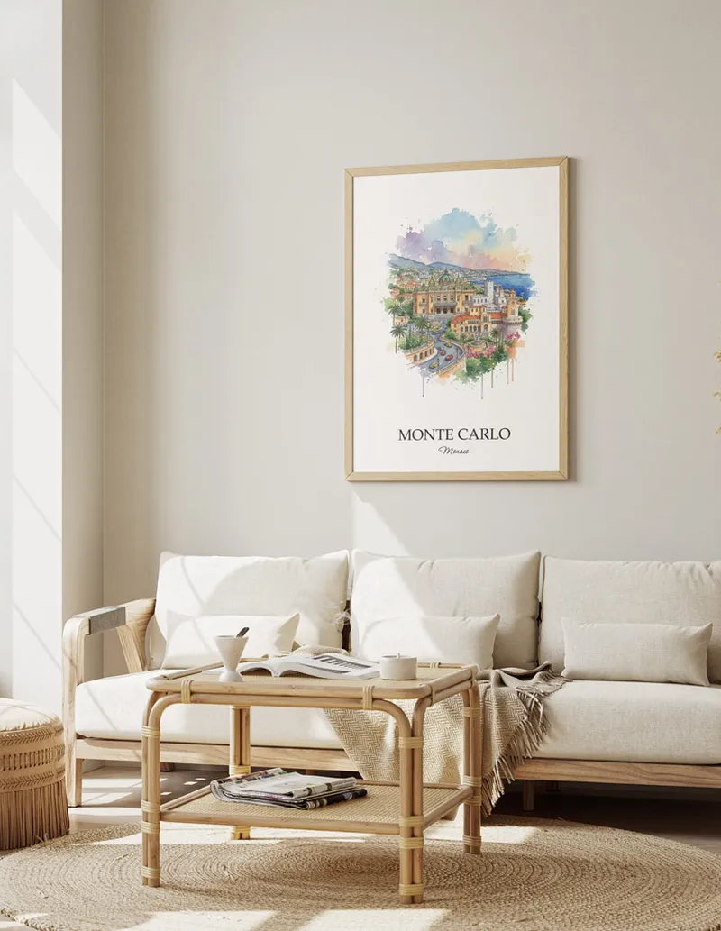 Framed wall art featuring Monte Carlo, Monaco in a light wood frame hanging above a sofa in a modern living room.