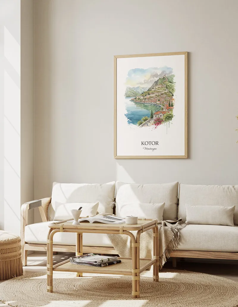 Framed wall art featuring Kotor, Montenegro in a light wood frame hanging above a sofa in a modern living room.