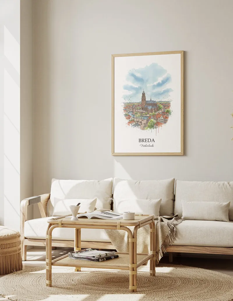 Framed wall art featuring Breda, Netherlands in a light wood frame hanging above a sofa in a modern living room.