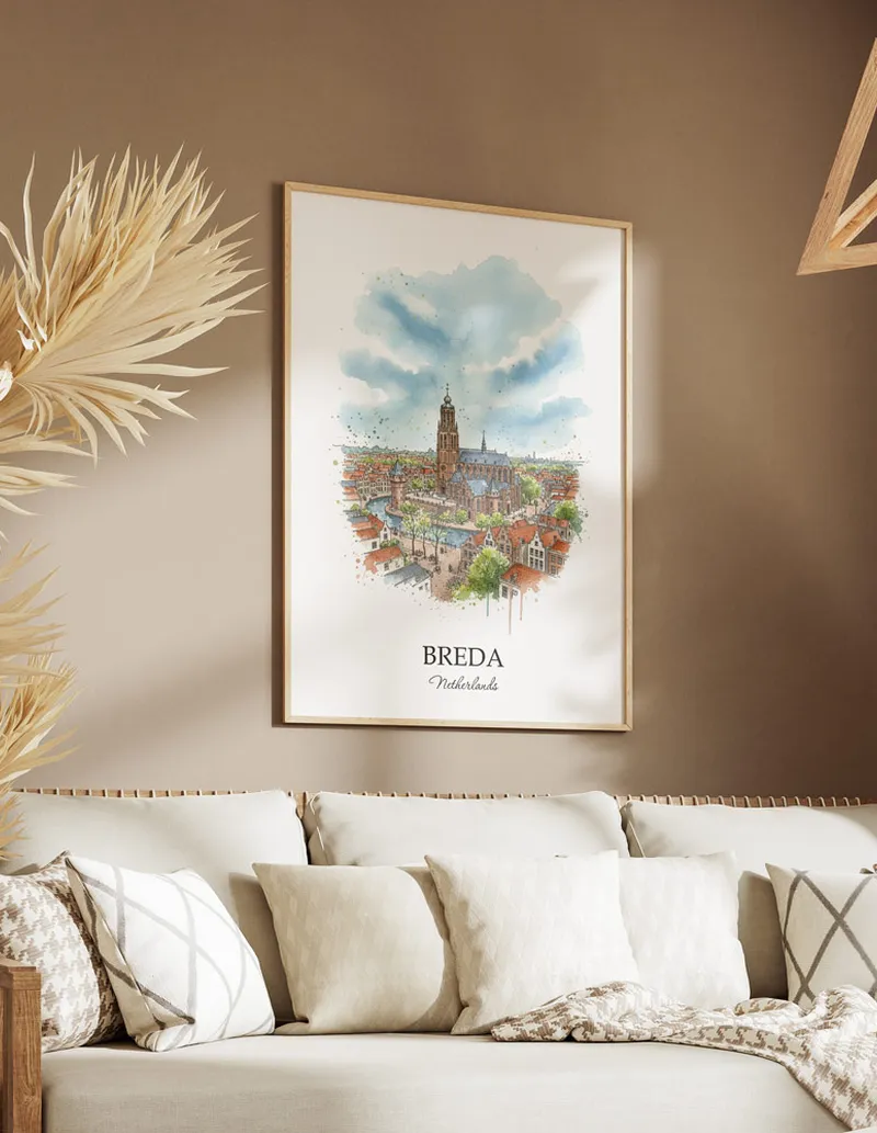 Vintage travel poster of Breda city, Netherlands in a light frame displayed above a sofa in a bright boho interior.