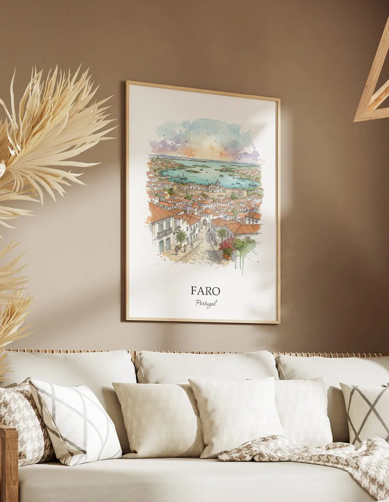 Vintage travel poster of Faro city, Portugal in a light frame displayed above a sofa in a bright boho interior.