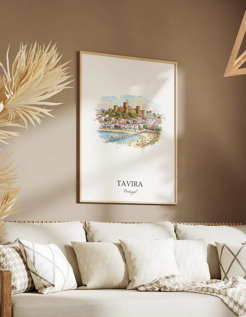 Vintage travel poster of Tavira city, Portugal in a light frame displayed above a sofa in a bright boho interior.