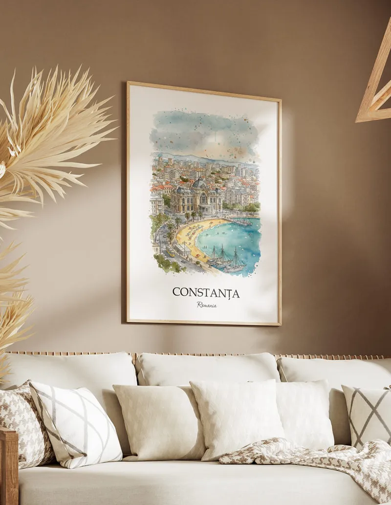 Vintage travel poster of Constan_a city, Romania in a light frame displayed above a sofa in a bright boho interior.