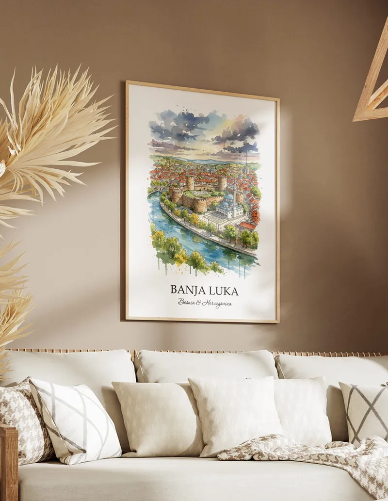 Vintage travel poster of Banja Luka city, Bosnia & Herzegovina in a light frame displayed above a sofa in a bright boho interior.
