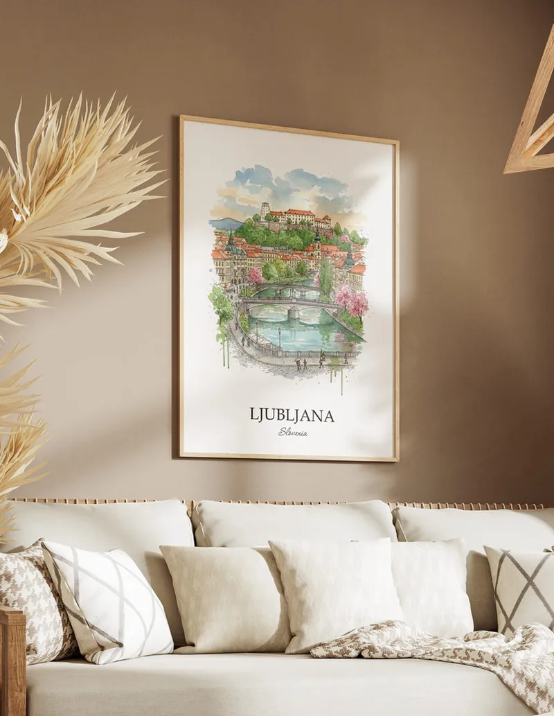 Vintage travel poster of Ljubljana city, Slovenia in a light frame displayed above a sofa in a bright boho interior.