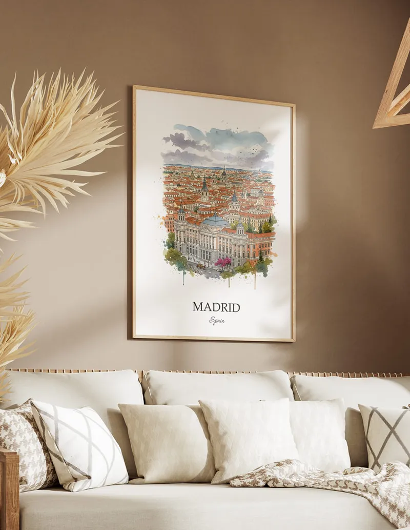 Vintage travel poster of Madrid city, Spain in a light frame displayed above a sofa in a bright boho interior.