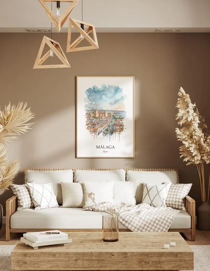 A gorgeous boho-inspired living space with a framed vintage travel poster of Málaga city on display.