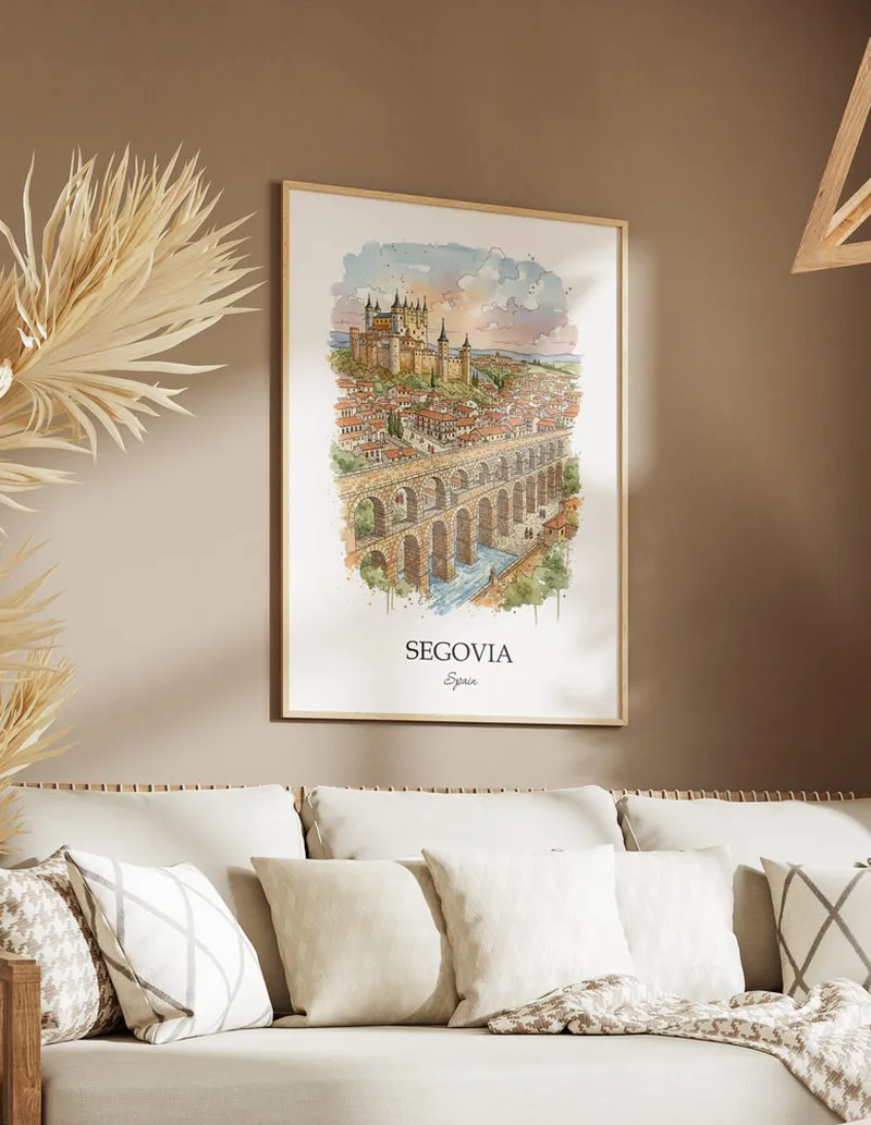 Vintage travel poster of Segovia city, Spain in a light frame displayed above a sofa in a bright boho interior.