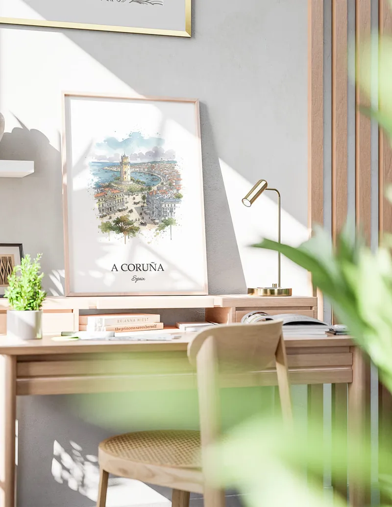 Cozy, well-lit workspace with a minimalist poster of A Coruña, Spain in a light frame sitting on the desk.