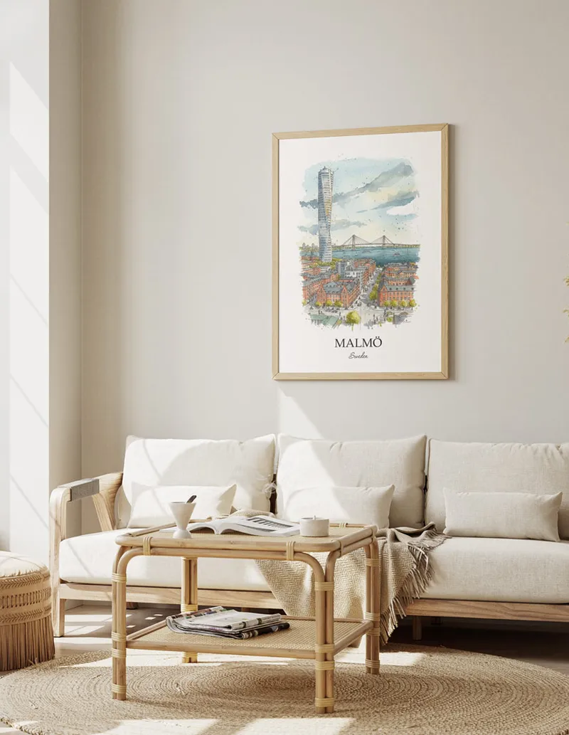 Framed wall art featuring Malmö, Sweden in a light wood frame hanging above a sofa in a modern living room.