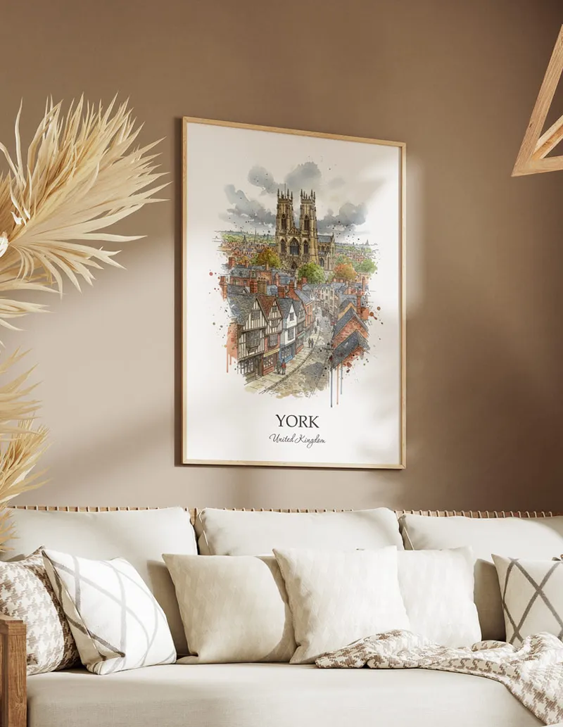 Vintage travel poster of York city, United Kingdom in a light frame displayed above a sofa in a bright boho interior.