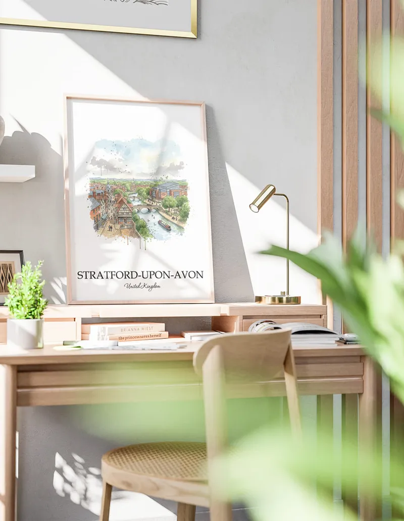 Cozy, well-lit workspace with a minimalist poster of Stratford-upon-Avon, United Kingdom in a light frame sitting on the desk.