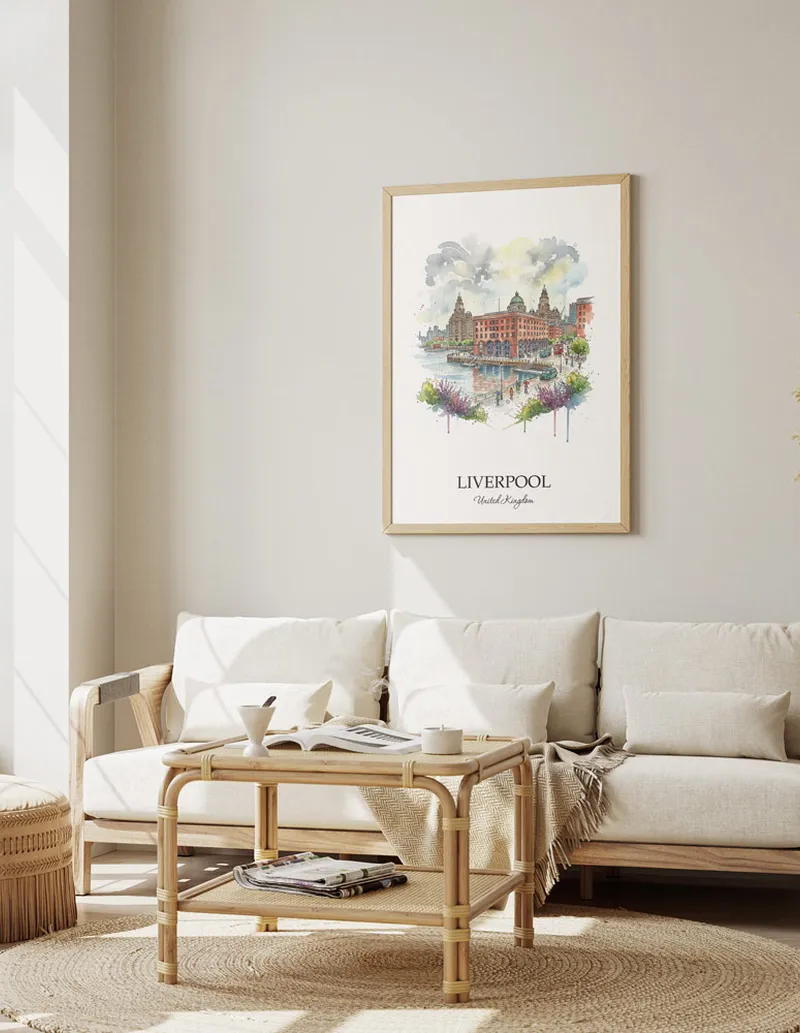 Framed wall art featuring Liverpool, United Kingdom in a light wood frame hanging above a sofa in a modern living room.