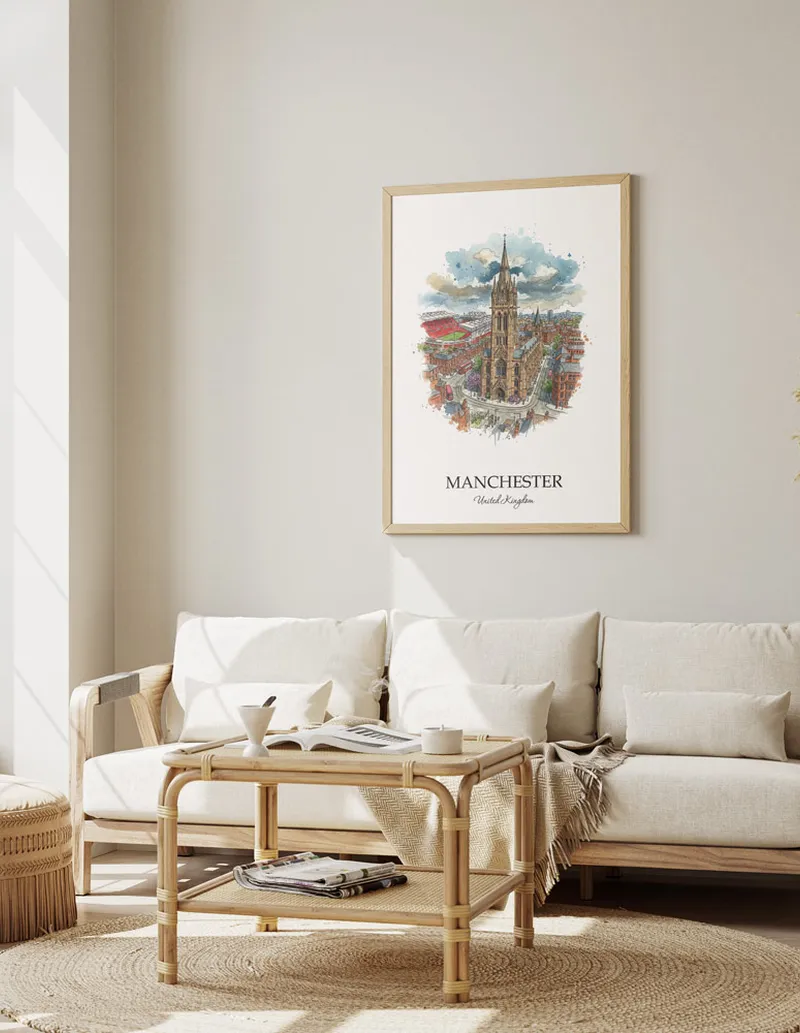 Framed wall art featuring Manchester, United Kingdom in a light wood frame hanging above a sofa in a modern living room.