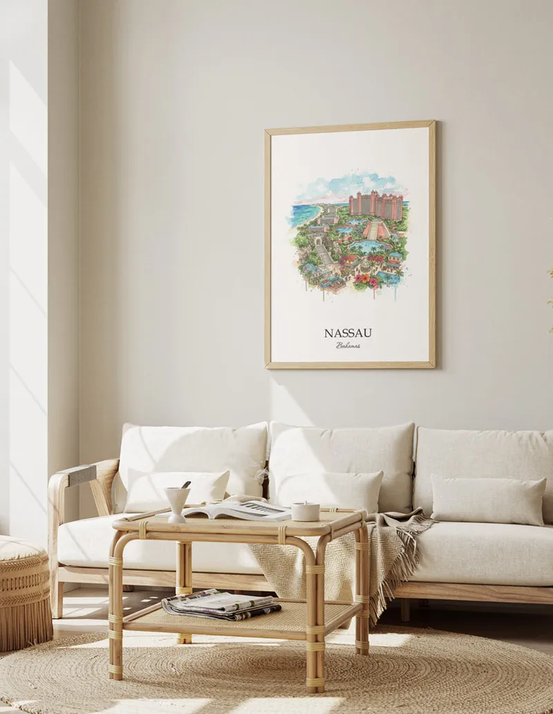 Framed wall art featuring Nassau, Bahamas in a light wood frame hanging above a sofa in a modern living room.