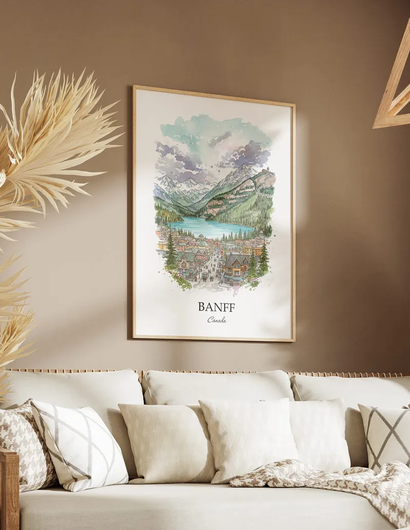 Vintage travel poster of Banff city, Canada in a light frame displayed above a sofa in a bright boho interior.