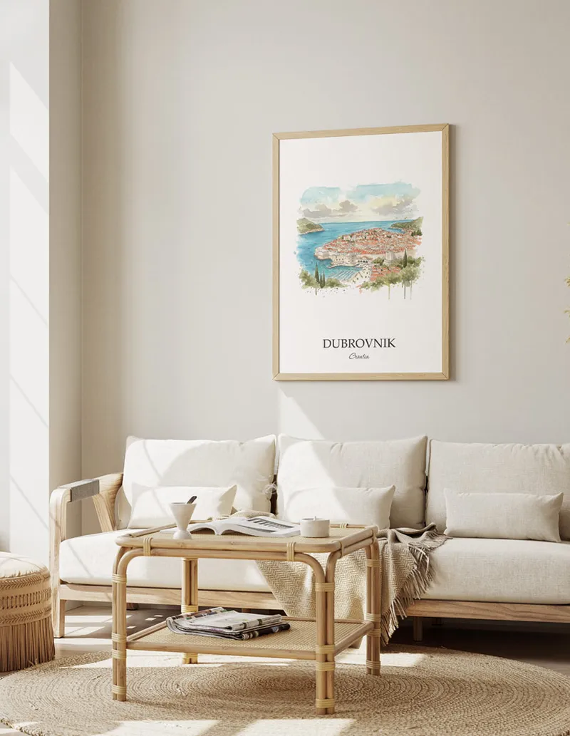 Framed wall art featuring Dubrovnik, Croatia in a light wood frame hanging above a sofa in a modern living room.