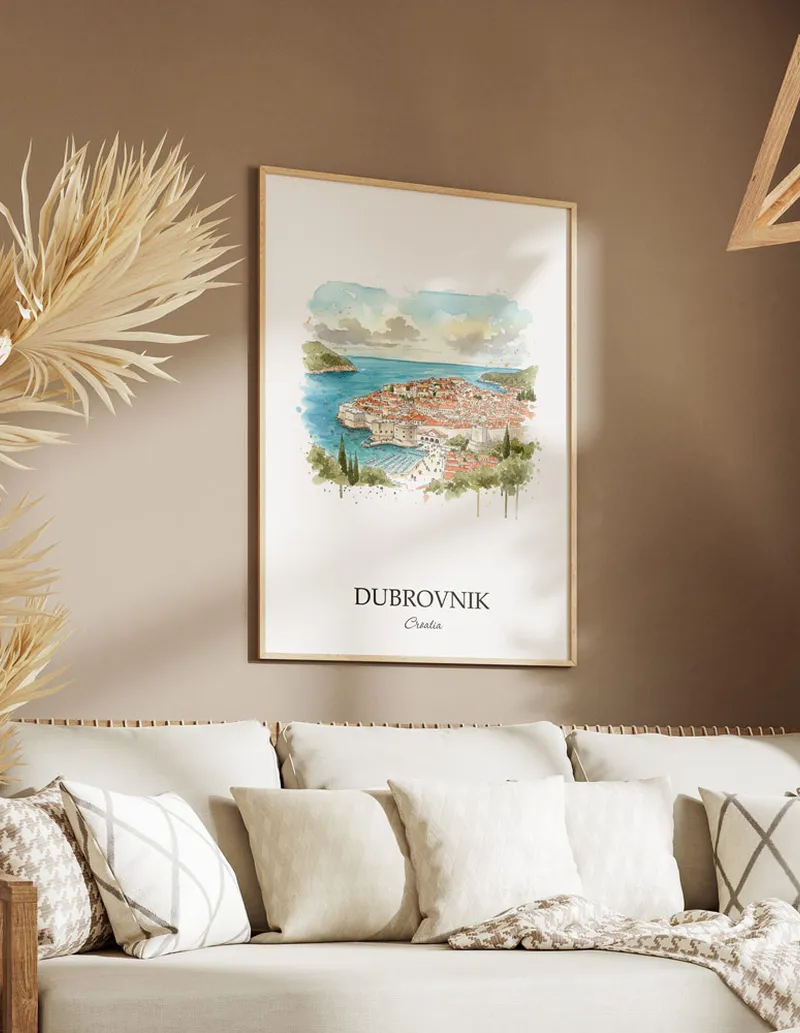 Vintage travel poster of Dubrovnik city, Croatia in a light frame displayed above a sofa in a bright boho interior.