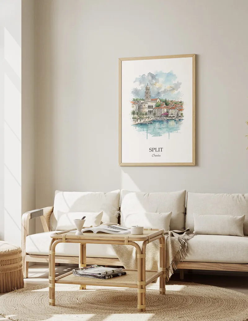 Framed wall art featuring Split, Croatia in a light wood frame hanging above a sofa in a modern living room.