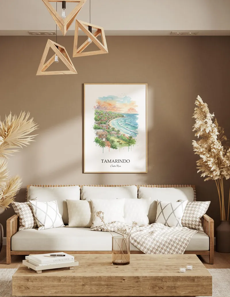 A gorgeous boho-inspired living space with a framed vintage travel poster of Tamarindo city on display.