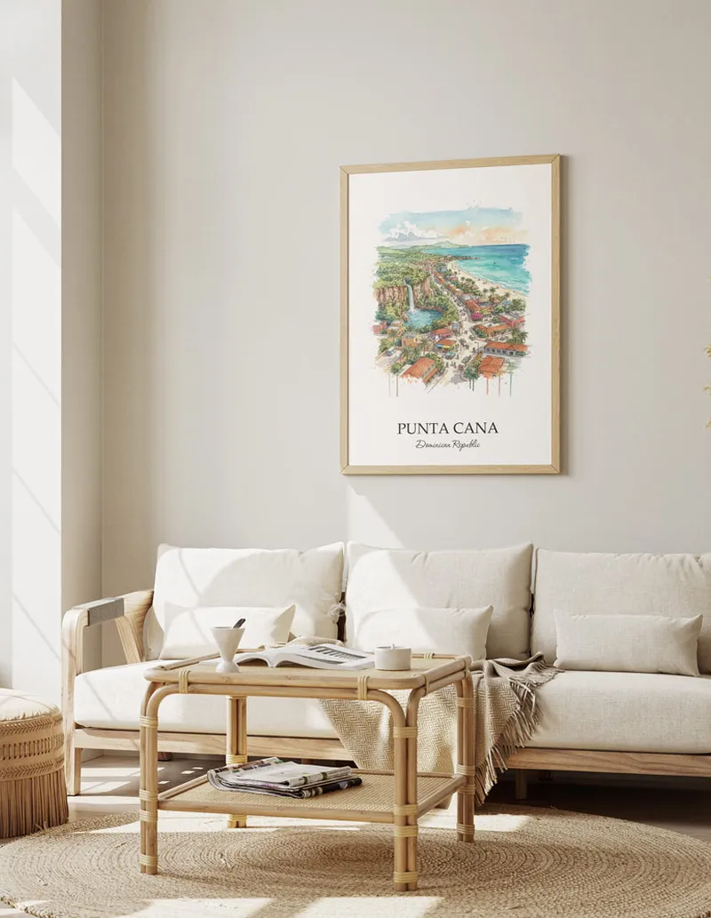 Framed wall art featuring Punta Cana, Dominican Republic in a light wood frame hanging above a sofa in a modern living room.