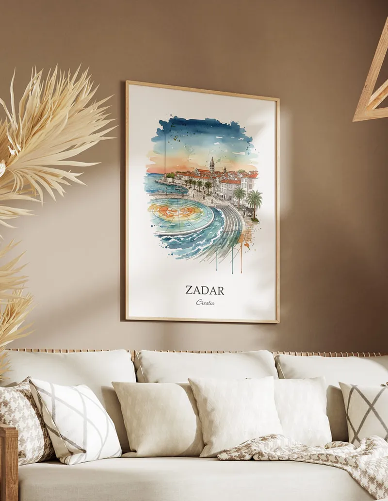 Vintage travel poster of Zadar city, Croatia in a light frame displayed above a sofa in a bright boho interior.