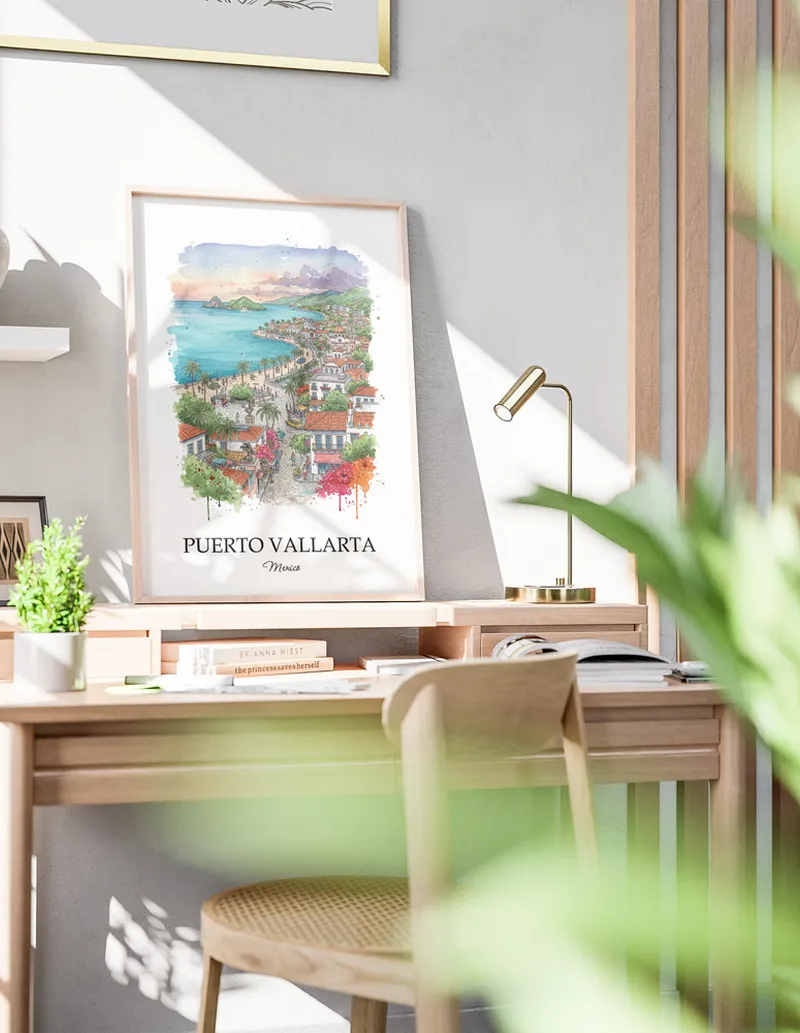 Cozy, well-lit workspace with a minimalist poster of Puerto Vallarta, Mexico in a light frame sitting on the desk.
