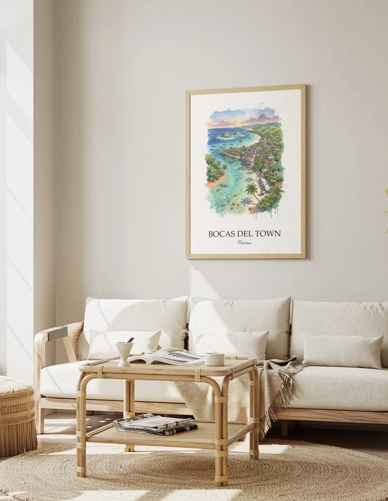 Framed wall art featuring Bocas del Town, Panama in a light wood frame hanging above a sofa in a modern living room.