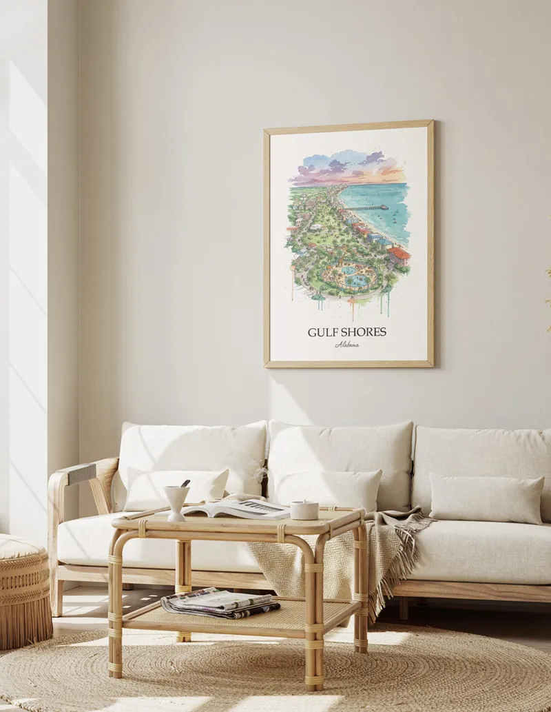 Framed wall art featuring Gulf Shores, USA - Alabama in a light wood frame hanging above a sofa in a modern living room.
