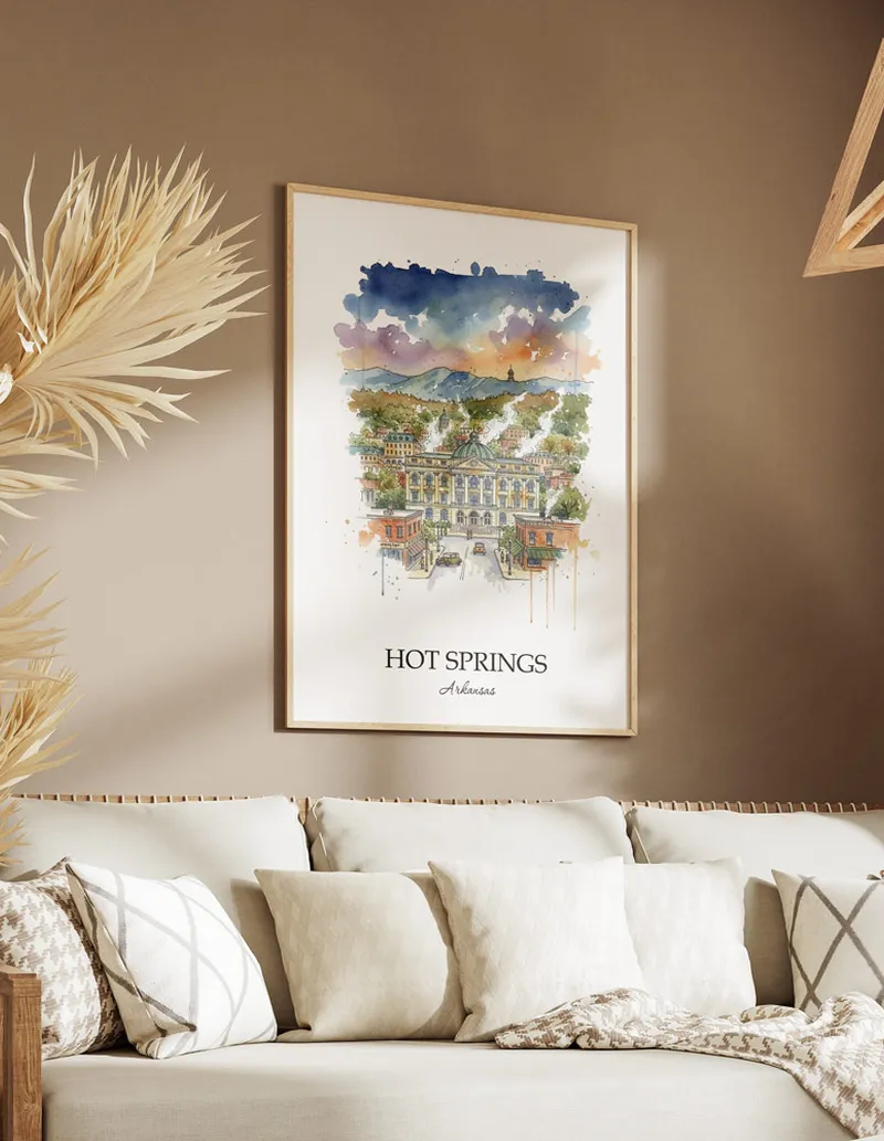 Vintage travel poster of Hot Springs city, USA - Arkansas in a light frame displayed above a sofa in a bright boho interior.