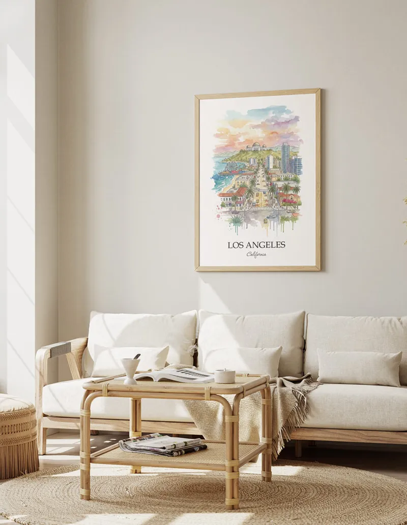 Framed wall art featuring Los Angeles, USA - California in a light wood frame hanging above a sofa in a modern living room.