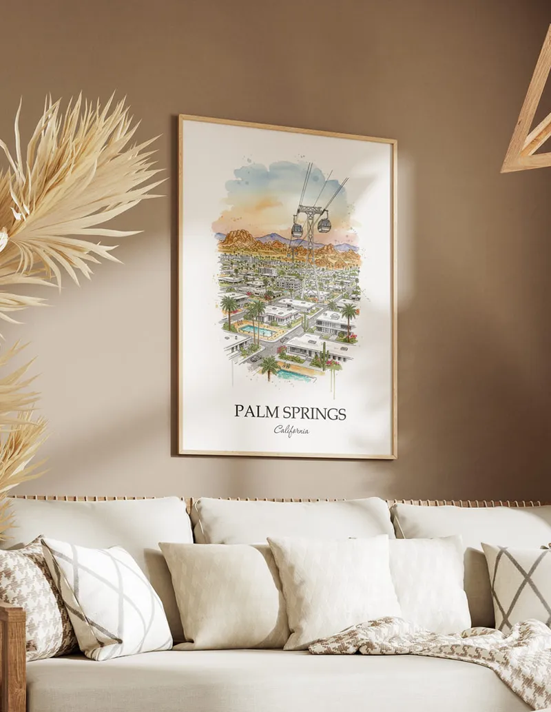 Vintage travel poster of Palm Springs city, USA - California in a light frame displayed above a sofa in a bright boho interior.