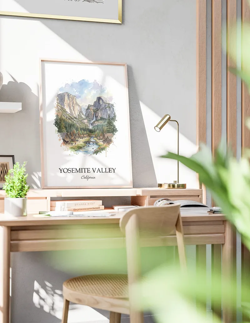 Cozy, well-lit workspace with a minimalist poster of Yosemite Valley, USA - California in a light frame sitting on the desk.