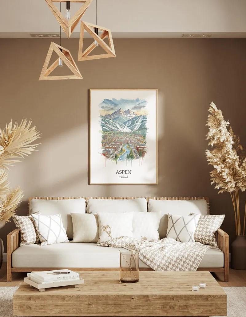 A gorgeous boho-inspired living space with a framed vintage travel poster of Aspen city on display.